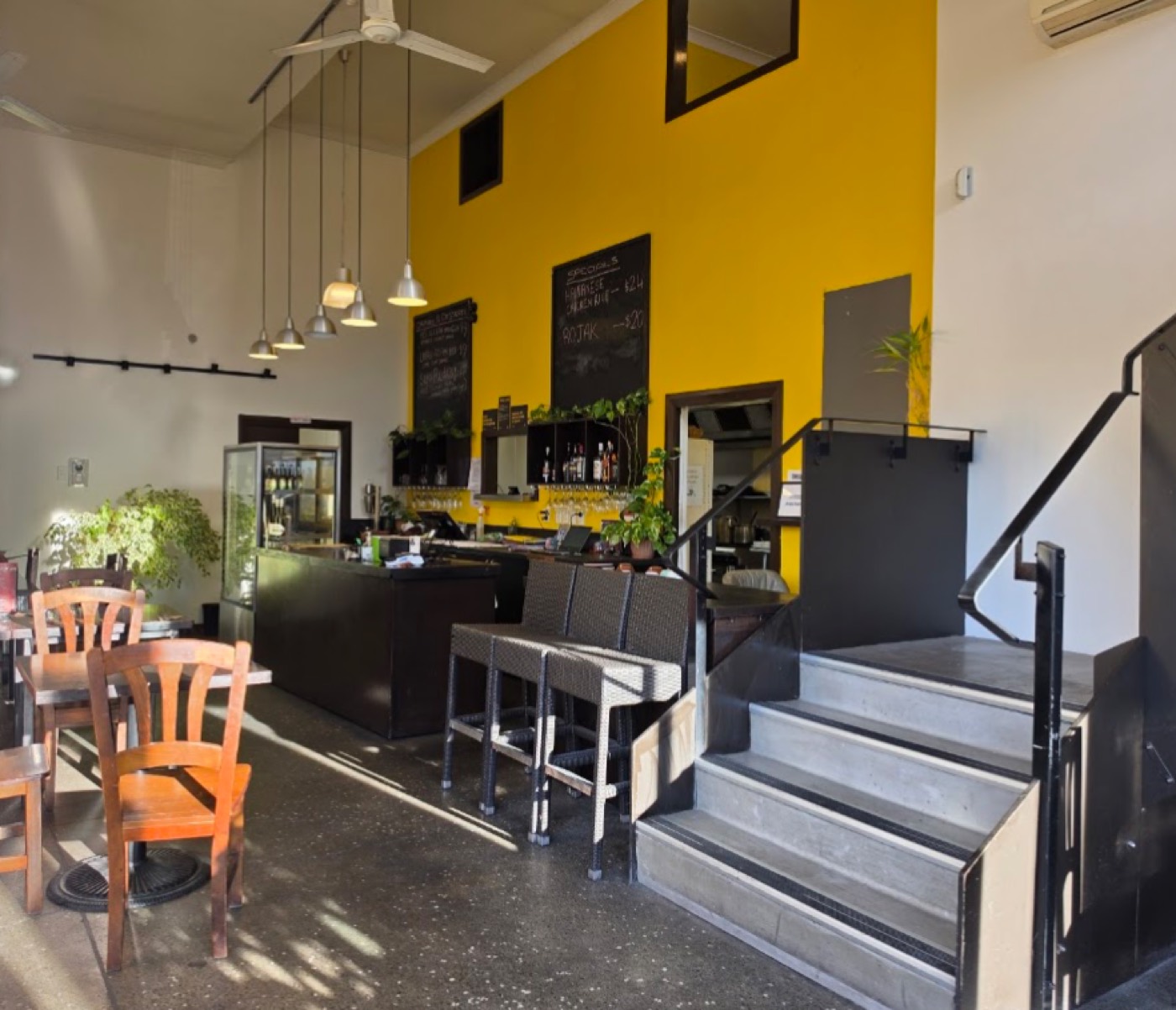 The dining room — tables, bar stools and the counter